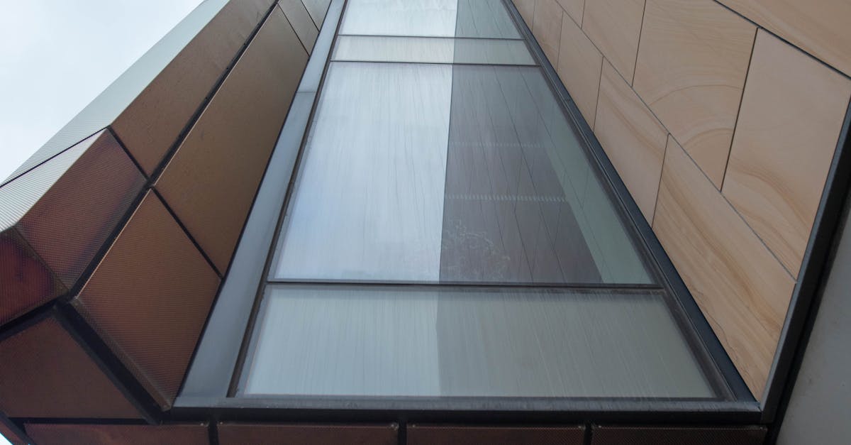 Person looking stressed while holding bills and paperwork at a kitchen table, calculator nearby, worried about emergency funds.